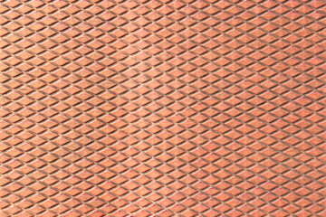 Rusty metal sheet with a repeating diamond pattern