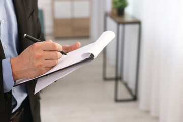 Real estate appraisal. Inspector with clipboard conducting property valuation at home, closeup....
