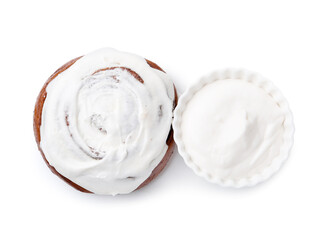 Tasty cinnamon roll with cream isolated on white, top view