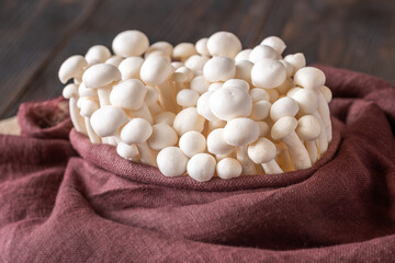 Fresh white beech mushrooms elegantly arranged in textile