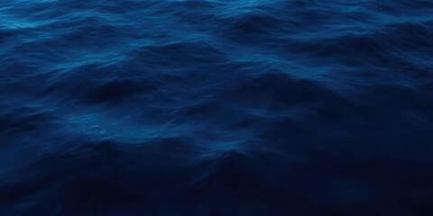 Dark blue abstract water surface with subtle gradient effects, blurred horizon, waveless