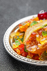 Candied peel and fruit orange, kumquat, tangerine, cherry, mango and others Sugar-coated fruit fresh tasty food dish delicious gourmet food background on the table rustic food top view copy space