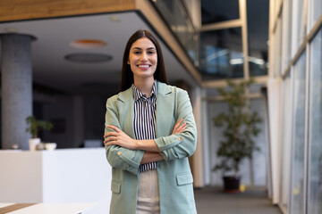 Determined Latina business leader posing for a portrait at work