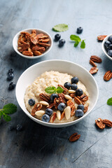 Oatmeal porridge with blueberry, almonds, and pecan healthy food breakfast.
