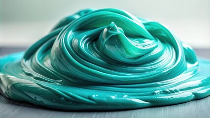 Close-up shot of teal slime on a smooth surface, tactile experience, tactile exploration, sensory stimulation