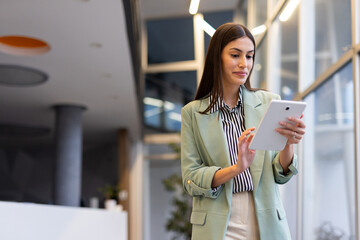 Ambitious Latina entrepreneur making business decisions using a tablet