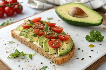 Fresh herbs like basil or parsley sprinkled on top of a slice of toasted almond flour bread topped with sliced avocado and halved tomato, toasted almond flour, farm to table