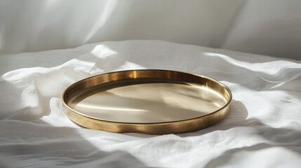 Minimalist golden tray on a white textured surface in natural light casting delicate shadows.