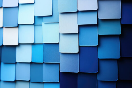 A wall of various shades of blue paint samples, showing a gradient of color.