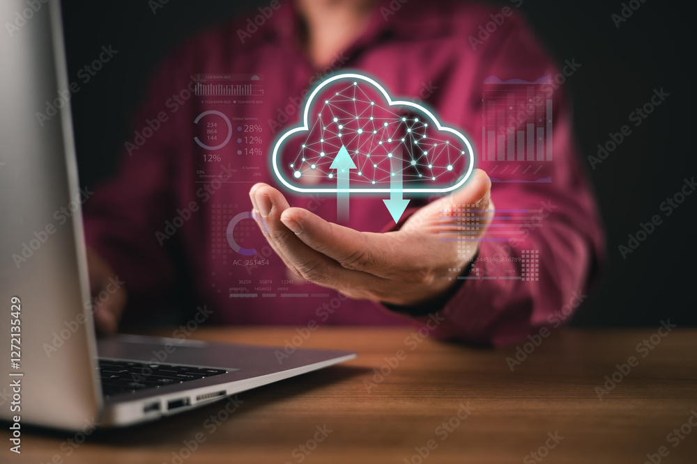 Poster a man uses a laptop while holding a futuristic holographic cloud icon with upload and download symbo