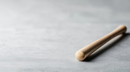 Naklejka premium Wooden Muddler on Grey Textured Background