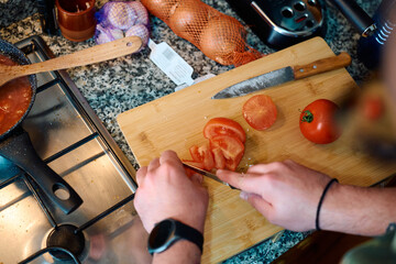 Cooking fresh tomato salsa in a home kitchen with vibrant ingredients