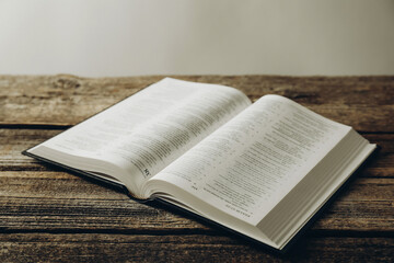 Fototapeta premium Open Holy Bible in English language on wooden table