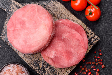 Two fresh slices of raw tuna fillet with spices and herbs