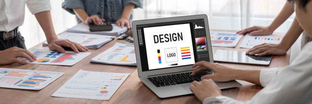 Graphic designer software for modern design of web page and commercial brisk ads showing on the computer screen - Powered by Adobe