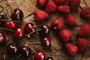 cherry and raspberry berries on a wooden table
