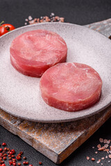 Two fresh slices of raw tuna fillet with spices and herbs