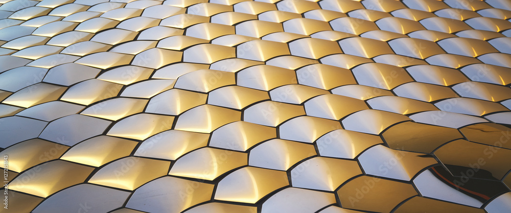 Poster a close-up view of a sophisticated pattern of hexagonal tiles in white and gold, creating a geometri