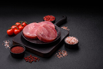 Two fresh slices of raw tuna fillet with spices and herbs