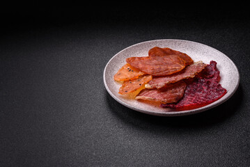Jerky, dried meat in the form of slices with salt, spices and herbs