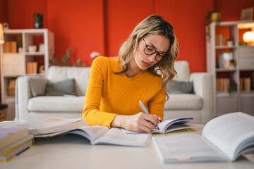 high school girl with eyeglasses study hard for exams at home
