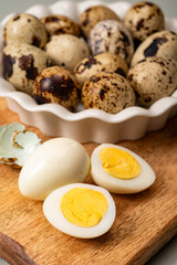 Fresh small spotted partridge or quail bird eggs uncooked and cooked