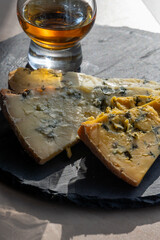 Cheese plate, English cow milk semi-soft, crumbly old blue stilton and blue shropshire cheeses...