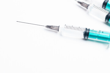 Sterile medical syringe with needle on a white background. Used for injections, vaccinations, and...