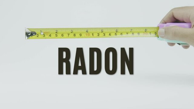 "Radon" text with a yellow tape measure on a white background, symbolizing precision, accuracy, and the measurement of radioactive gas levels and environmental safety in a clean, minimal video