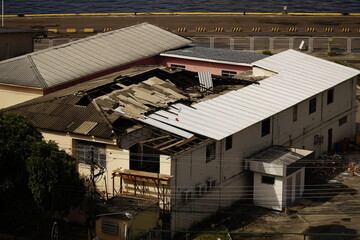 Fototapeta premium Hazardous asbestos, eternit as a building material. This material is banned in many countries due to the cancer risk posed by microfibers. Here the replacement of Eternit roof panels of aluminum.