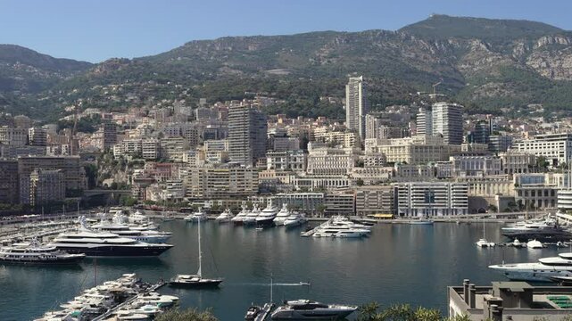 Port of Monaco with luxury yachts and the city in the background.