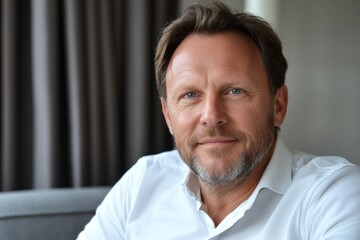 Fototapeta premium Professional man with beard smiles confidently in modern indoor setting during daytime