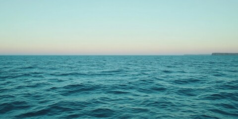 Obraz premium Serene and Relaxing Ocean Waves Beneath a Beautifully Calm Sky Full of Tranquility