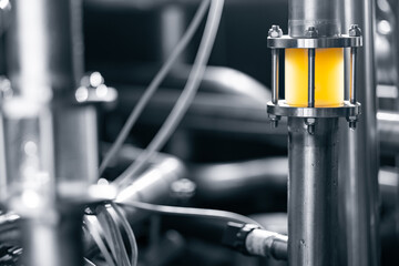 Obraz premium Modern beer factory equipment with stainless steel pipes and liquid flow