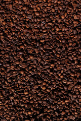 Close-up of roasted coffee beans forming a textured background for creative designs