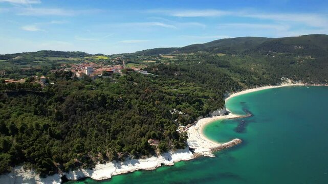 Riviera del Conero aerial panorama. Three white beaches view from drone. Spiaggia del Frate and Urbani. Sirolo, Marche, Italy. Turquoise Adriatic sea. 4K high flight. Scenic coastline.