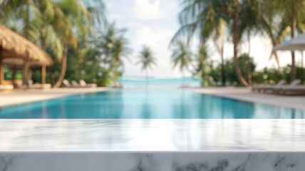 Fototapeta premium A smooth white marble table top in the foreground, with a blurred tropical resort swimming pool and lush greenery in the background, creating a bright, summery setting for product display or montage.