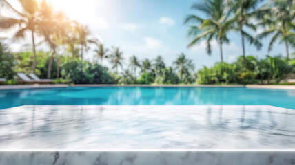 Fototapeta premium A smooth white marble table top in the foreground, with a blurred tropical resort swimming pool and lush greenery in the background, creating a bright, summery setting for product display or montage.