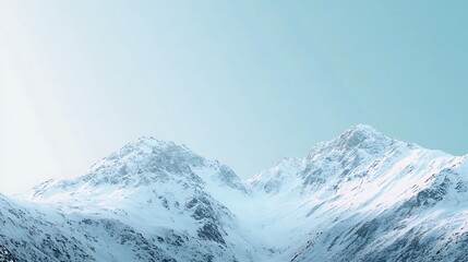 Obraz premium Snow covered mountains peak under a bright sky
