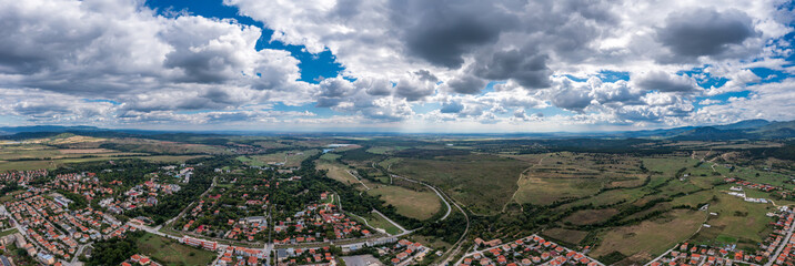 Panoramic aerial view of a mountain town under rolling hills
