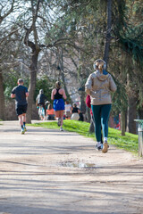 Fototapeta premium Back view of some runners running in the park