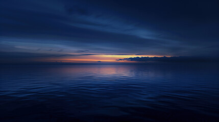Naklejka premium Calm waters reflect the deep blue hues of dusk over the horizon in this serene coastal landscape at twilight.