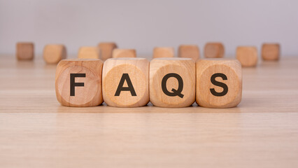 wooden blocks spelling 'FAQS' representing frequently asked questions, customer support, and help...