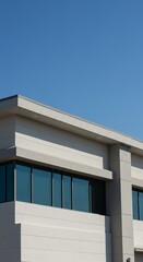 Obraz premium Modern architecture: minimalist white building against clear blue sky