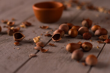 Hazelnut shell on a wooden background. Nuts scattered on the table.