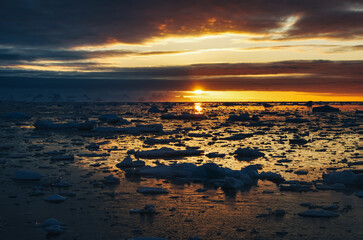 Antarctic Peninsula sunset, ice floes.