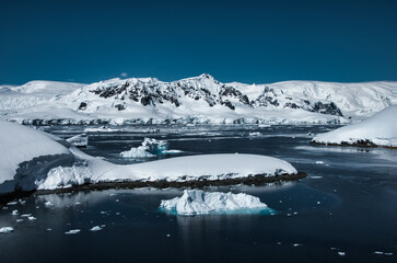 Fototapeta premium Antarctic Peninsula iceberg, snow-capped mountains.