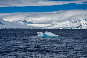 Antarctic Peninsula iceberg, dramatic icy landscape.