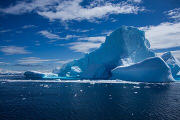 Antarctic Peninsula iceberg, dramatic icy landscape.