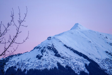 Snow capped mountain peak sunset